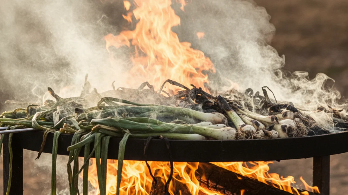 Imatge genèrica d'una graella plena de calçots rostint-se sobre el foc, amb fum.
