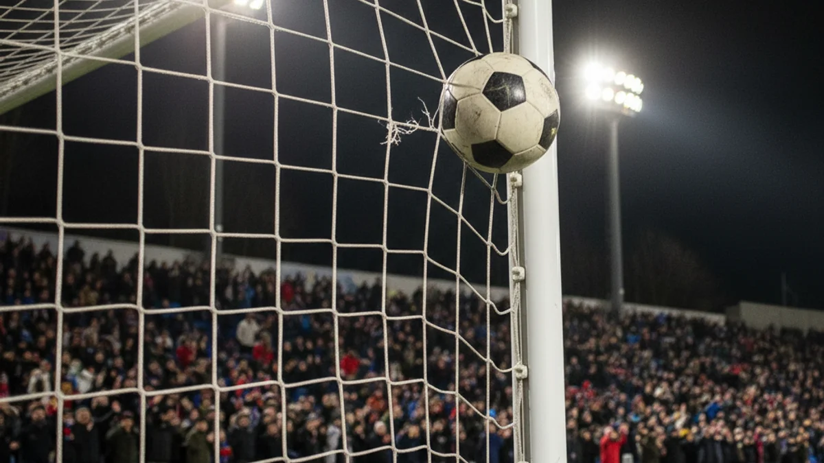 Generic image of a football ball hitting the top corner of the goal net during a night match.