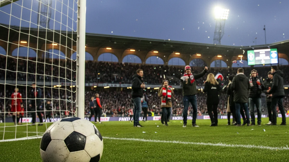 Generic image of a football stadium with floodlights on during an evening match.
