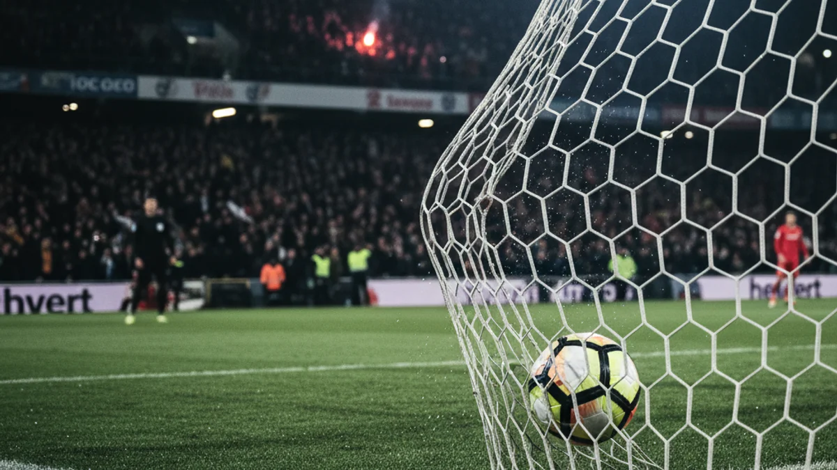 Generic image of a soccer ball hitting the net during a night match.