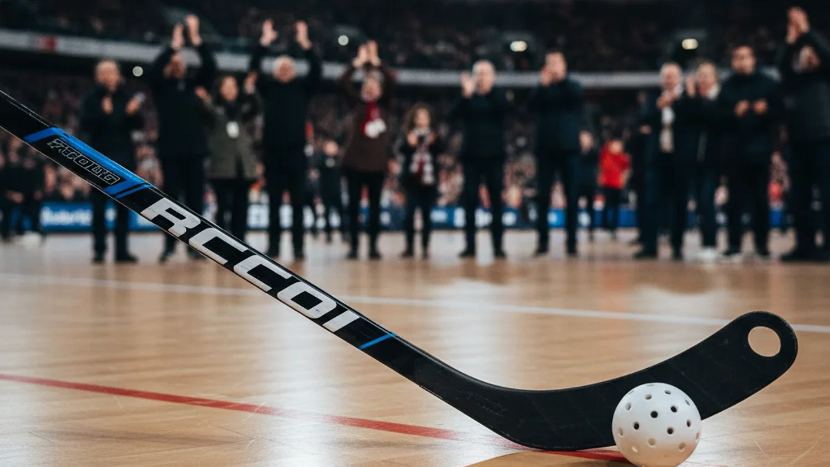 Generic image of a roller hockey stick and ball on a wooden rink floor.