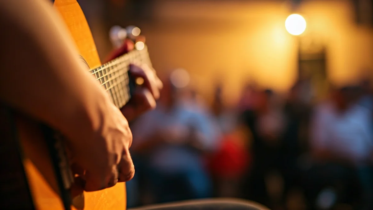 Imagen genérica de una guitarra flamenca con manos tocando, en un ambiente cálido e íntimo.