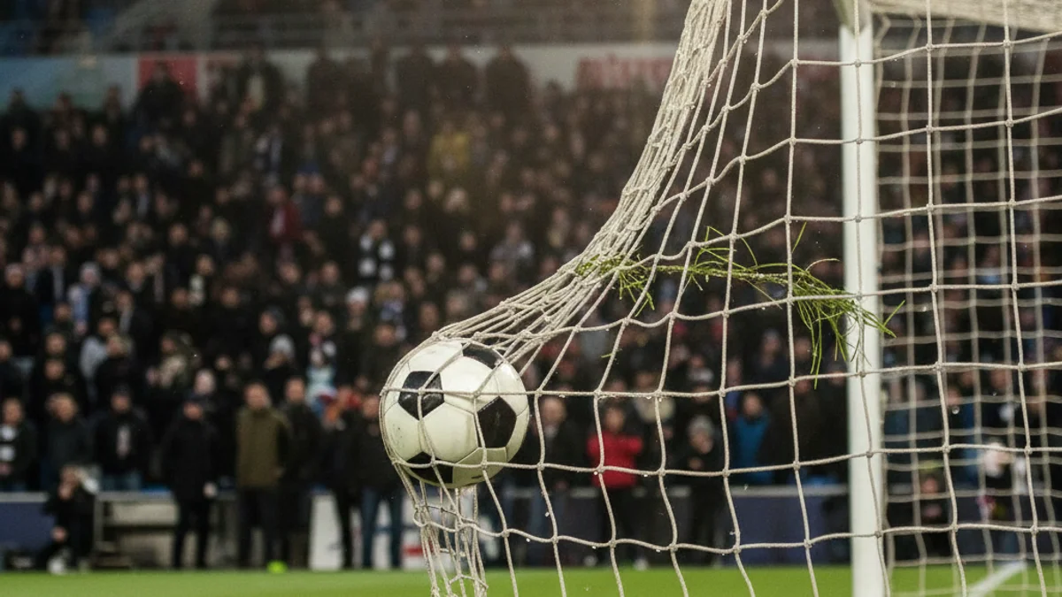 Generic image of a football goal during an official match under stadium lights.