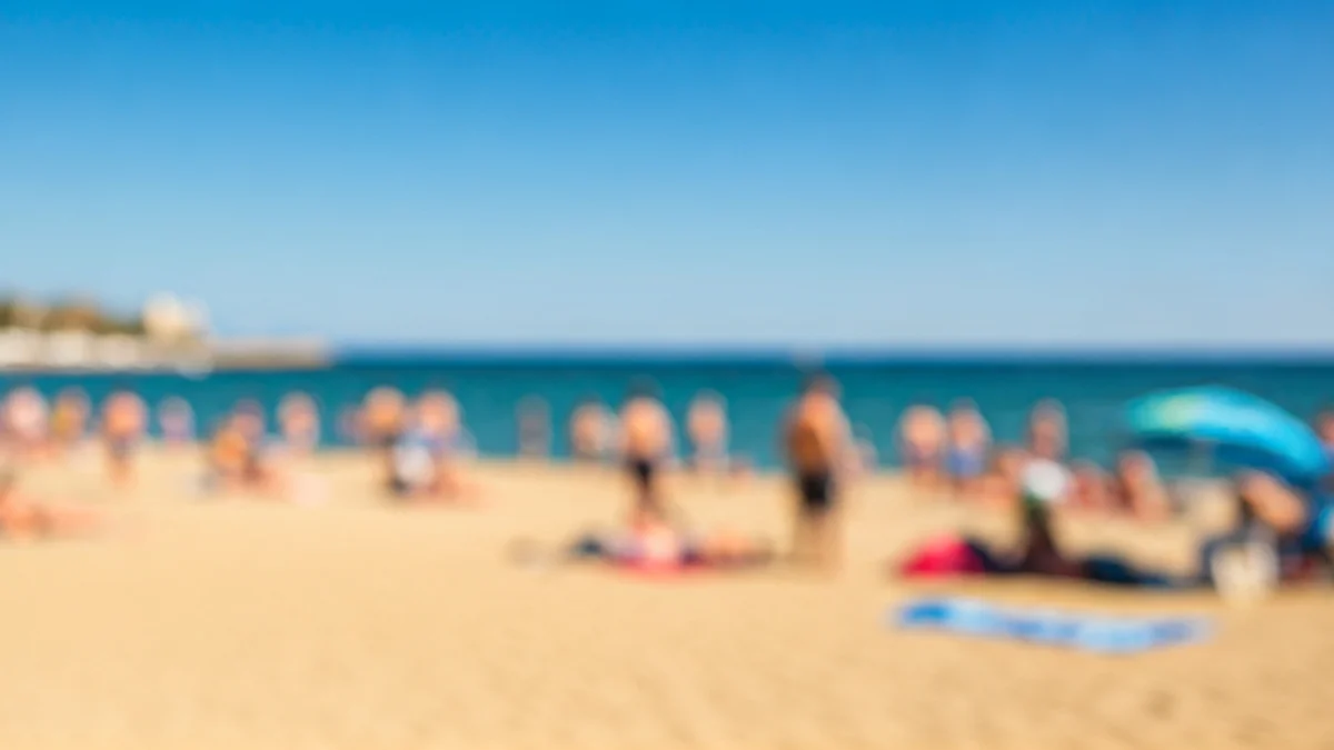 Generic image of a sunny beach on the Mediterranean coast, with golden sand and blue water, no identifiable people.