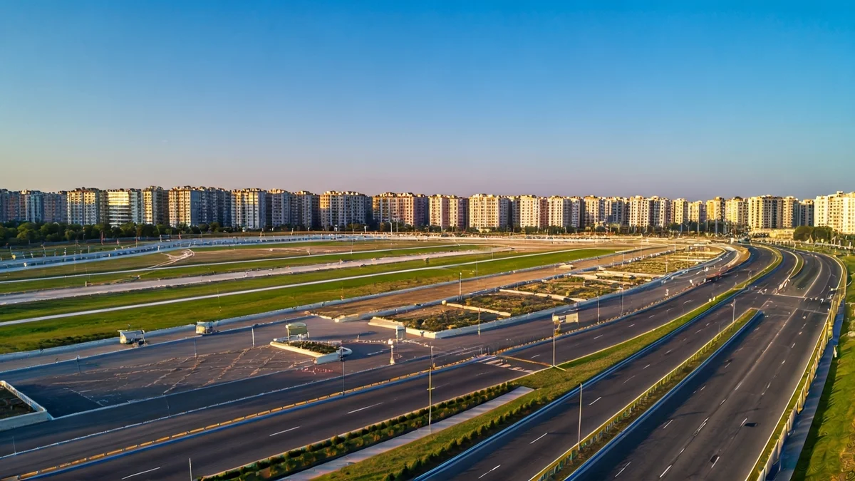 Generic image of an urban space undergoing transformation with green areas and parking.
