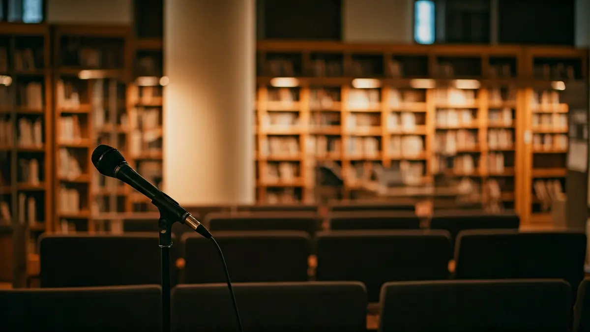 Generic image of a library interior with wooden bookshelves and a podium with a microphone.