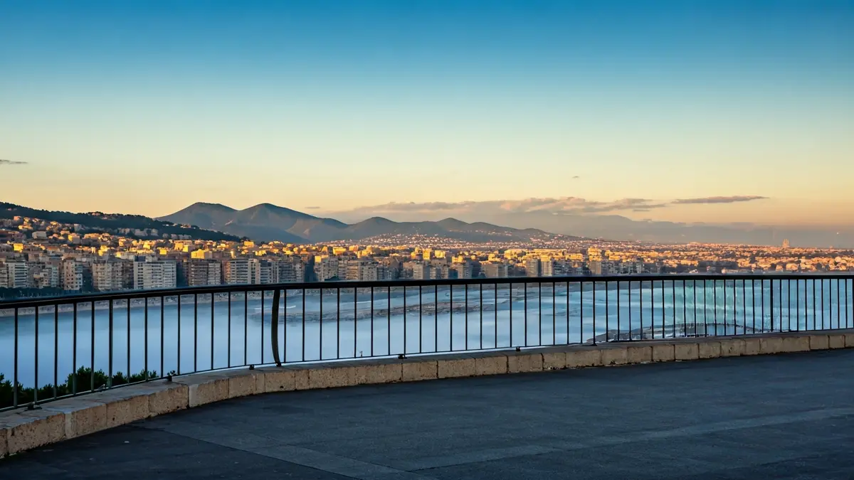 Generic image of a clear sky over a Mediterranean city with morning fog near the coast.