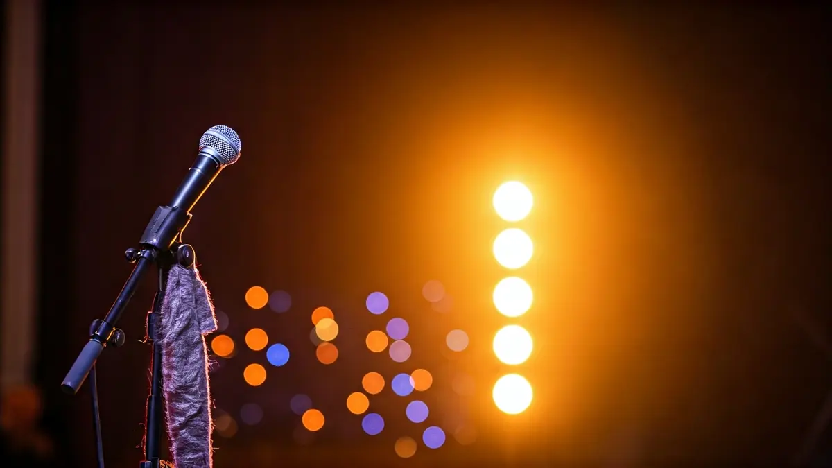 Generic image of a stage with colorful lights, suggesting an artistic performance.
