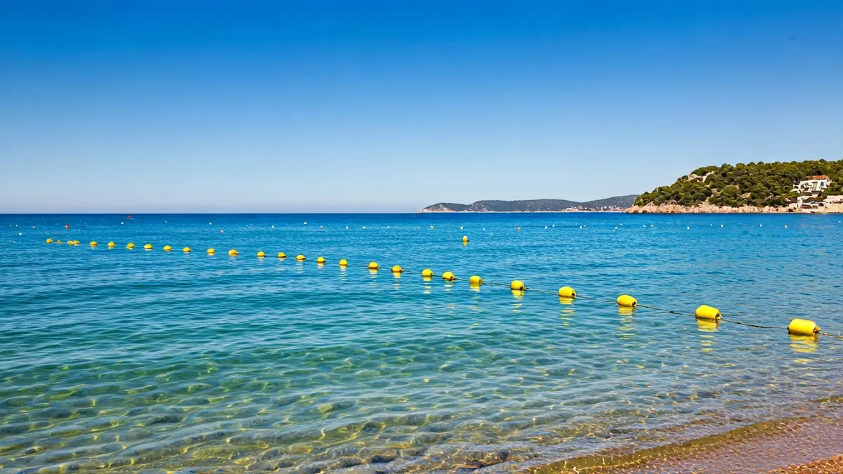 Generic image of yellow buoys marking a swimming area on a Mediterranean beach.