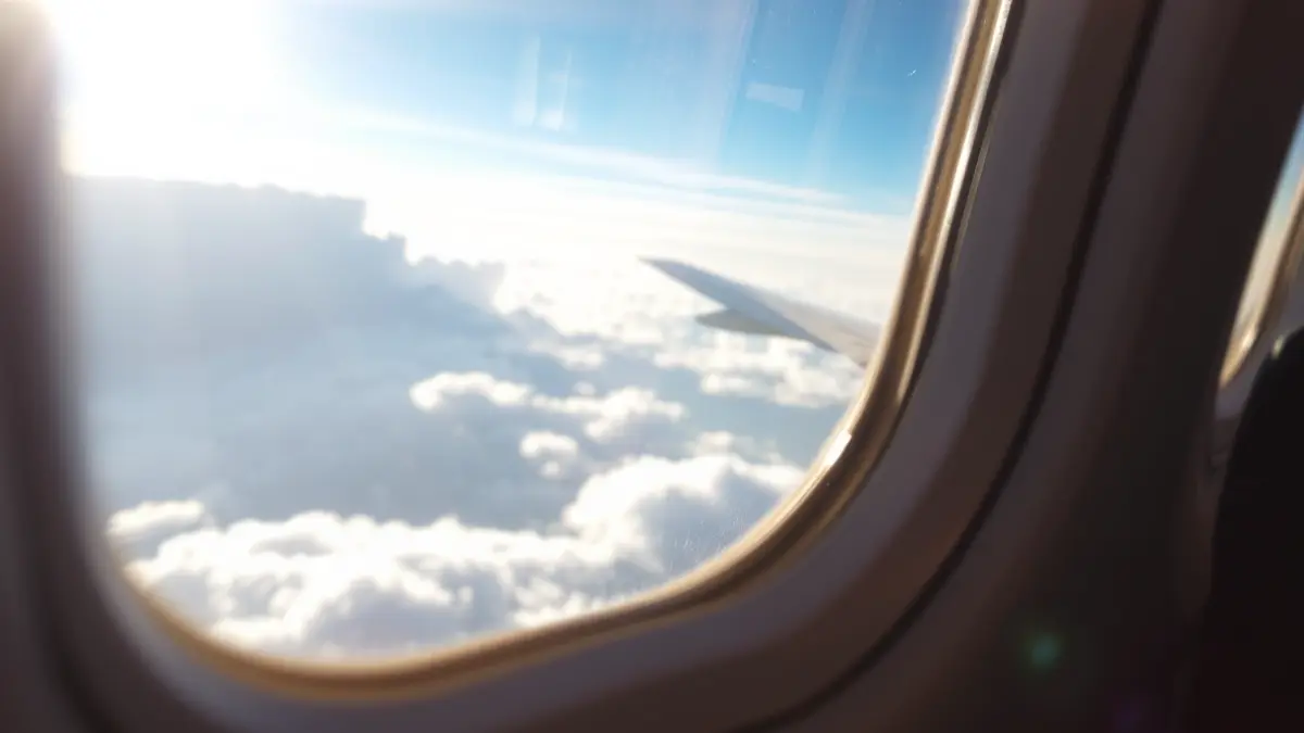 Generic image of an airplane window with cloud views.