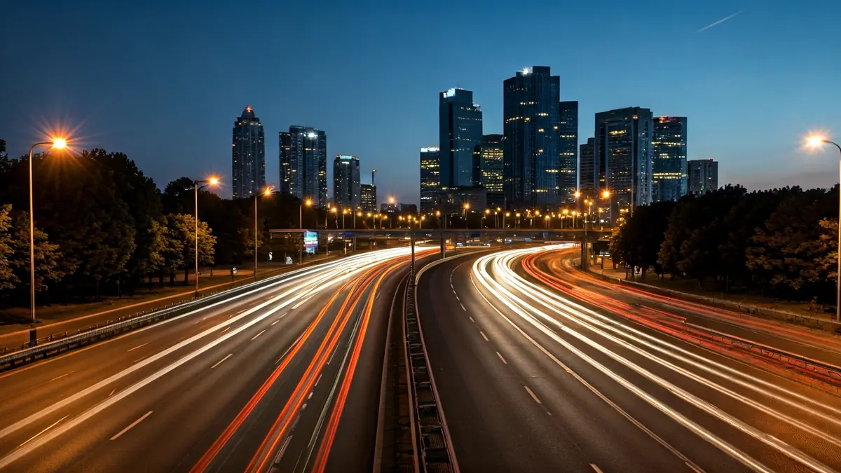 Generic image of a highway with heavy traffic at dusk, with cars heading towards a city.