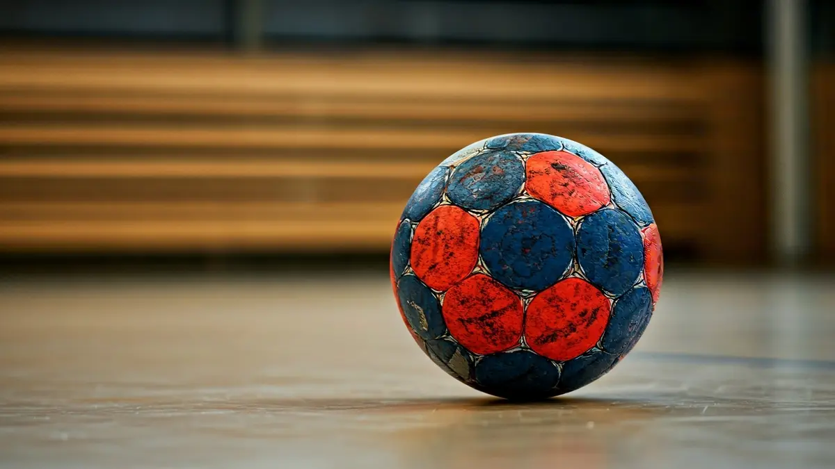 Generic image of a handball on a sports court.