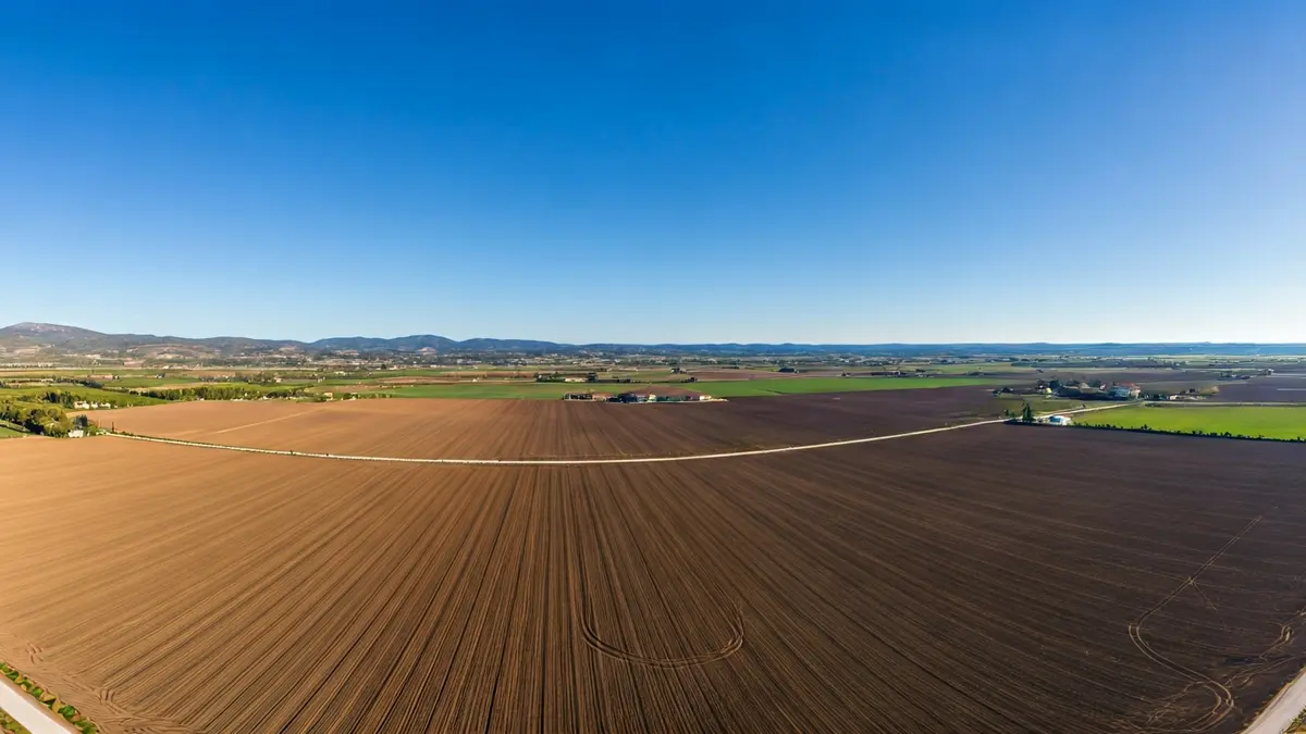 Generic image of an empty agricultural field under a blue sky, symbolizing a space for a solar project.