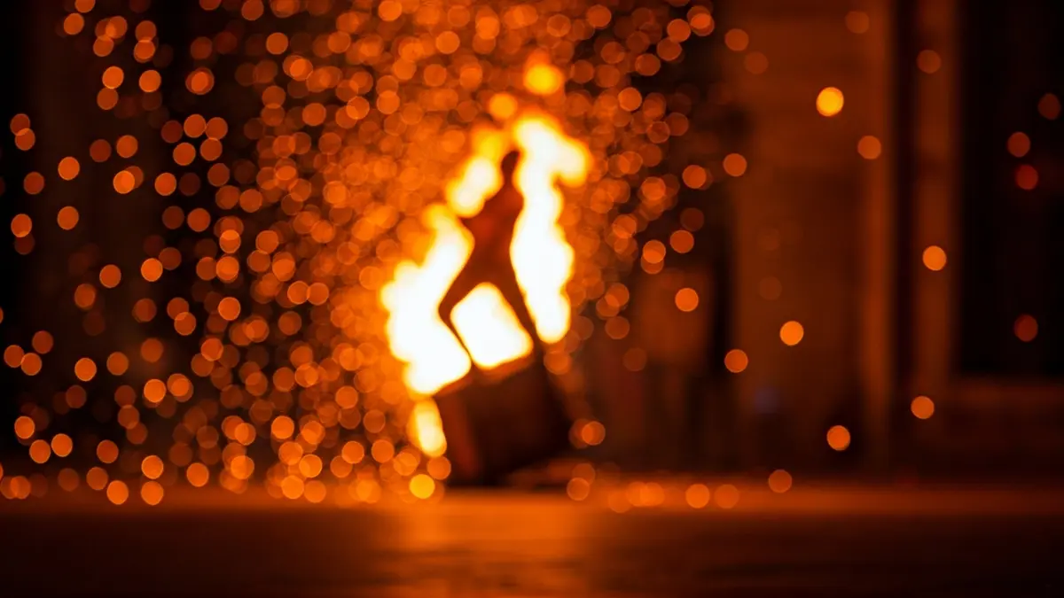 Image of a 'diables' drum with fire sparks in the background.