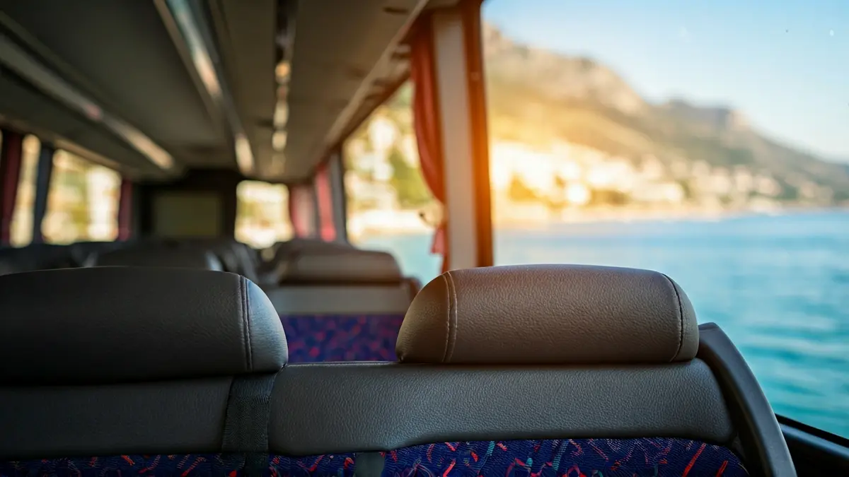 Generic image of a modern bus in motion, with a blurred Mediterranean landscape through the window.