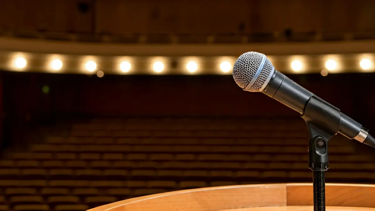 Generic image of a microphone on a podium, symbolizing a political debate.