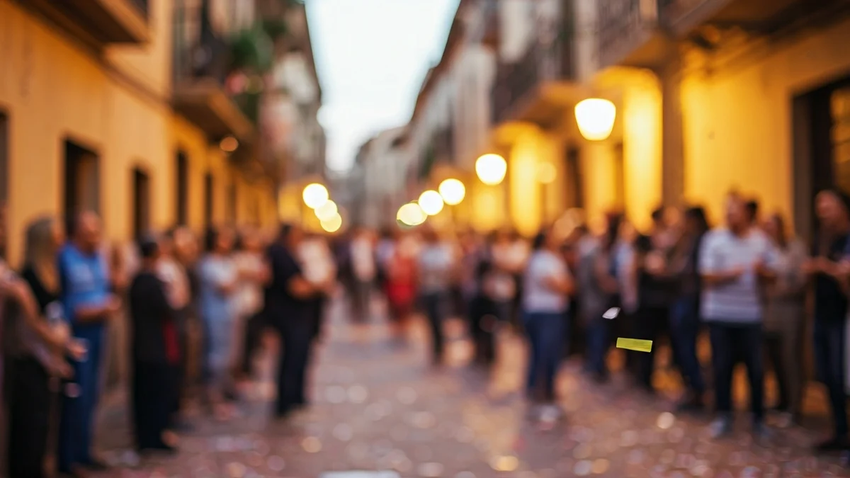 Generic image of a popular celebration with confetti and people in a street of a Catalan town.