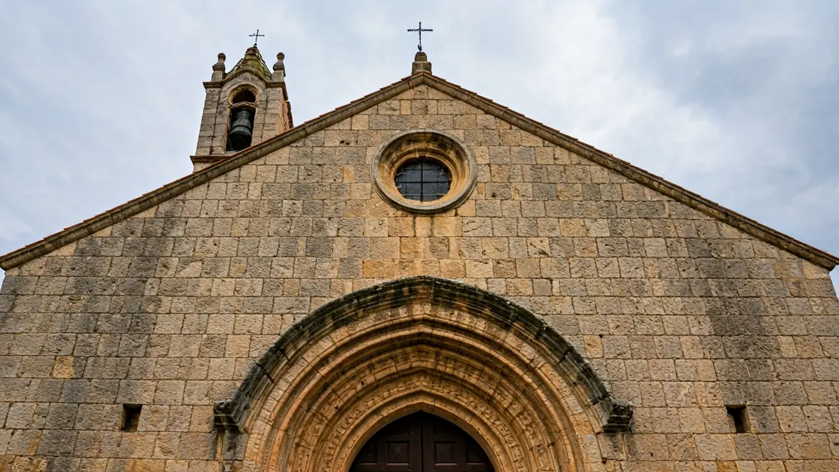 Façana de pedra d'una església antiga amb signes de despreniments.