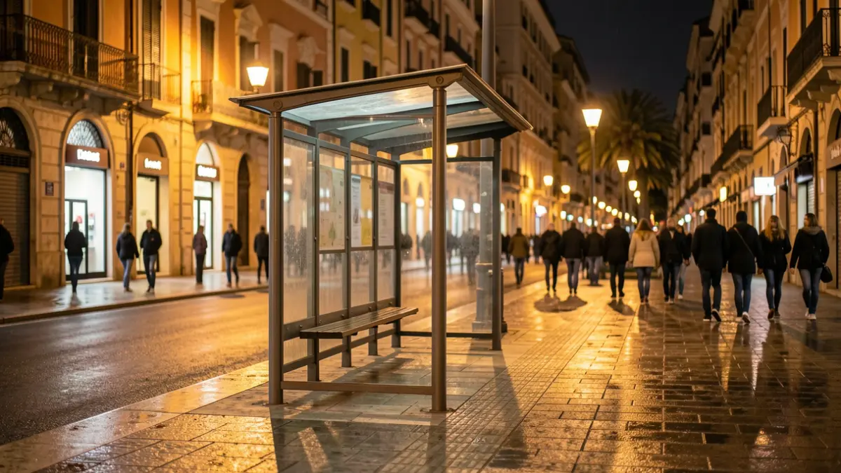 Generic image of an empty bus stop shelter in a Mediterranean city during a cool night.