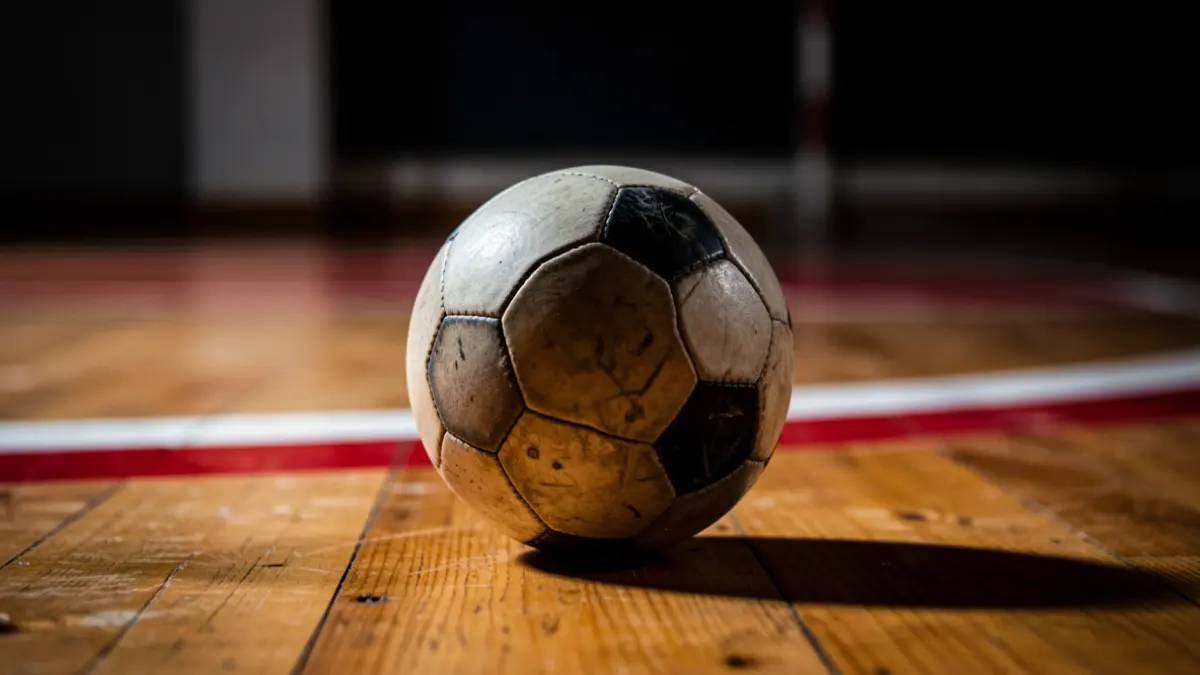 Generic image of a hockey ball on a court floor.