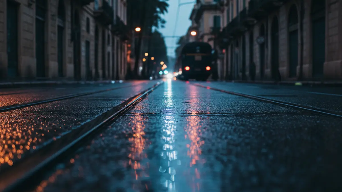 Generic image of emergency lights reflecting on wet asphalt near train tracks