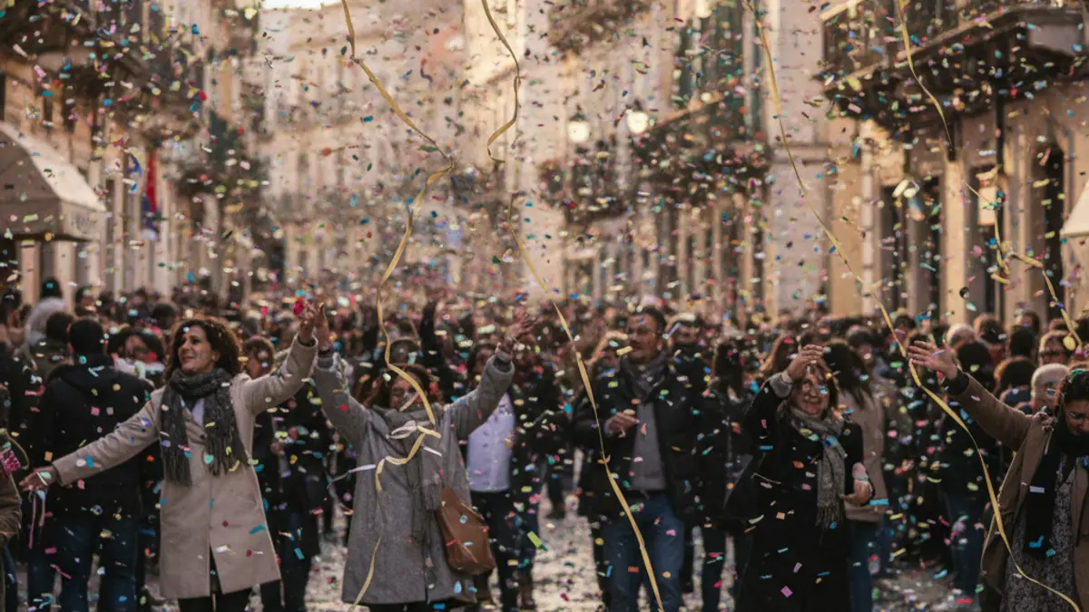Generic image of a parade with colorful confetti and streamers.
