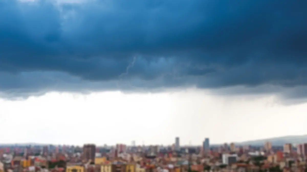 Image of a city under a stormy sky, with rain and distant lightning.