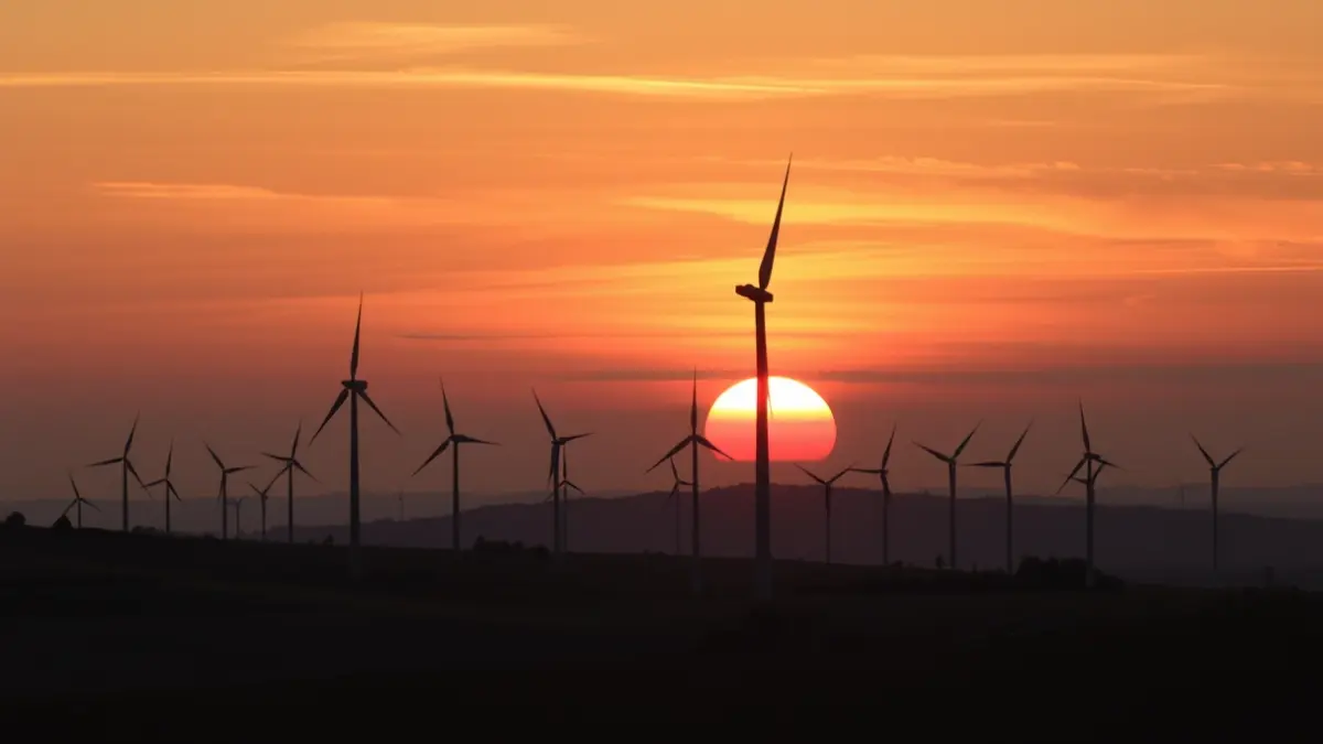 Generic image of wind turbines in a rural landscape at sunset.