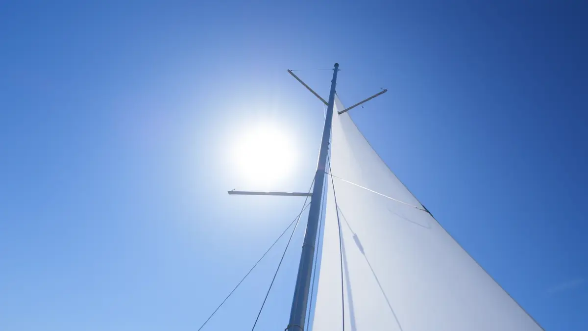 Generic image of a sailboat mast against a blue sky, suggesting a sailing competition.