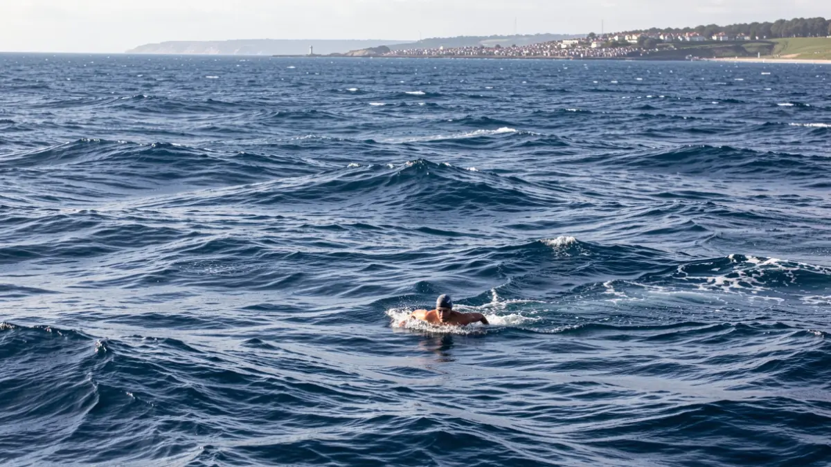 Lone swimmer in the open Atlantic waters during a demanding crossing.