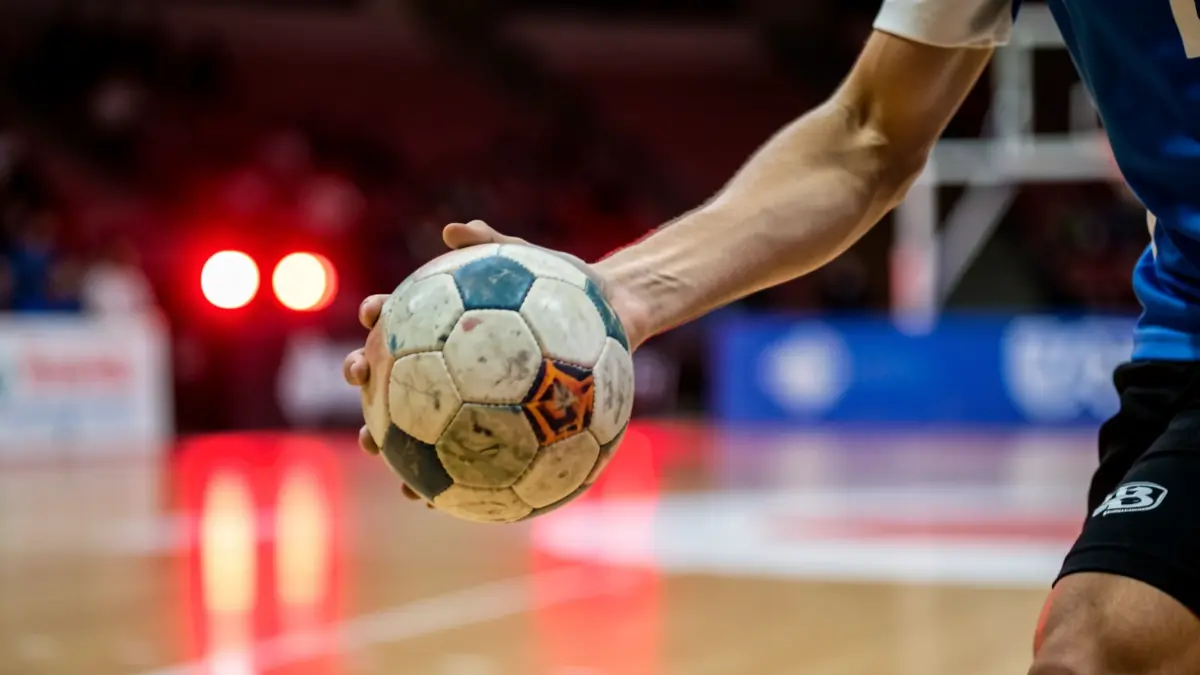 Handball player gripping the ball with their hand.