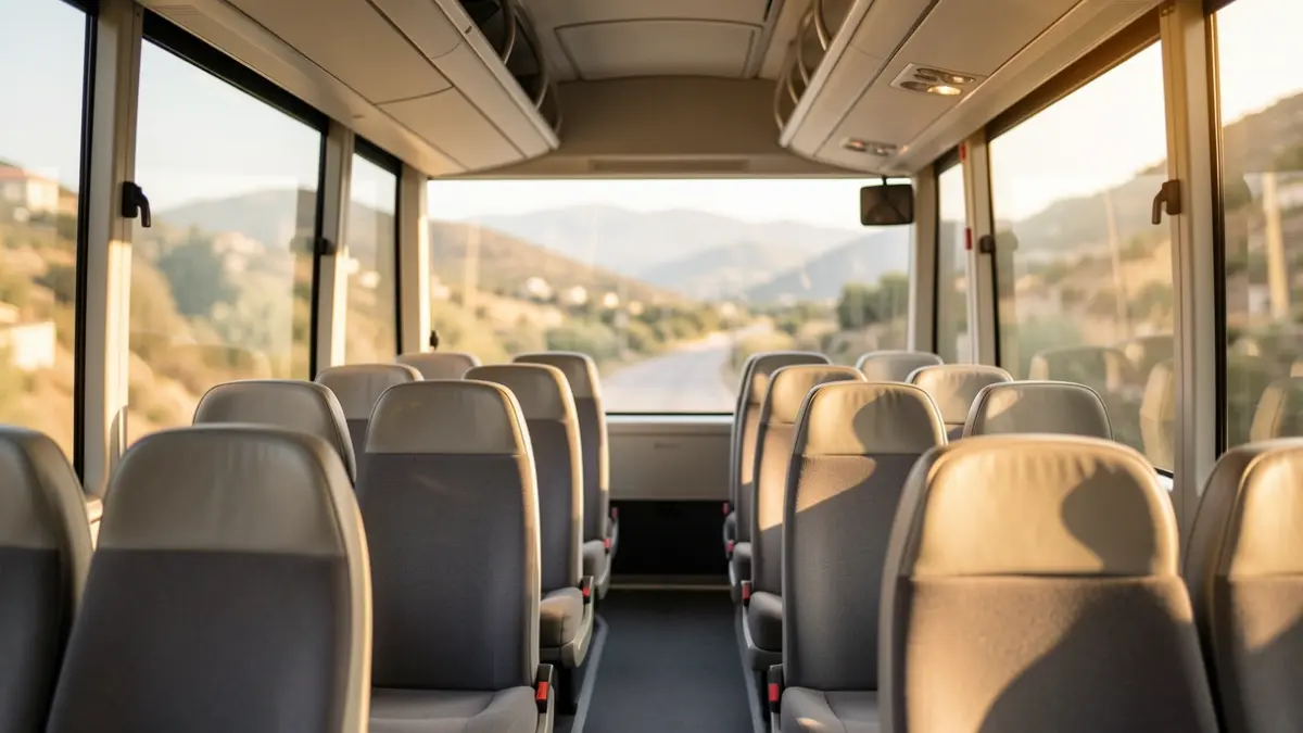 Interior de un autobús a demanda con paisaje borroso al fondo.