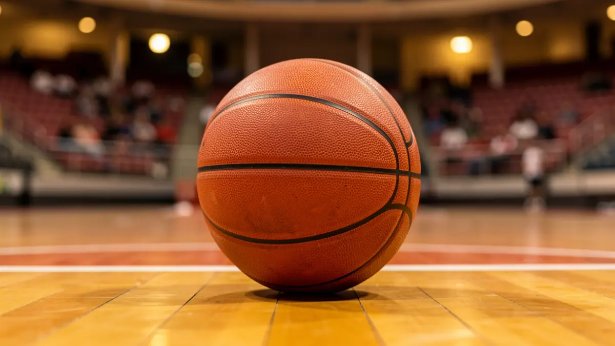 Generic image of a basketball on a wooden court.