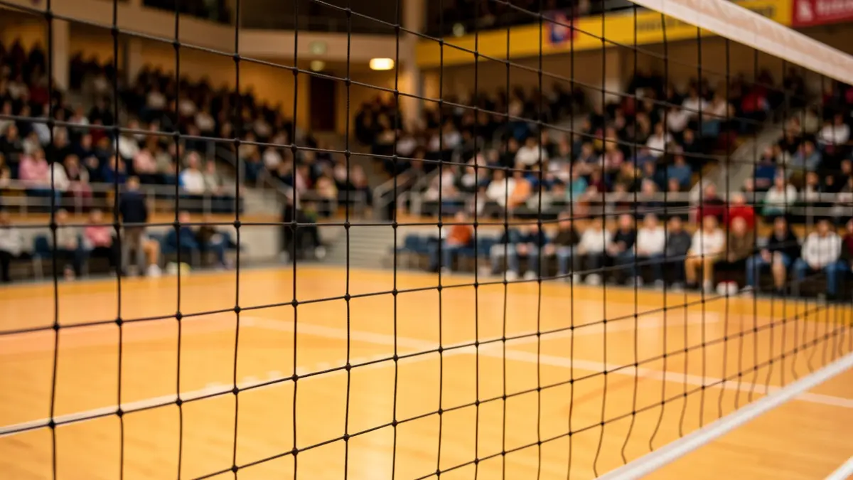 Generic image of a volleyball net in a sports hall.