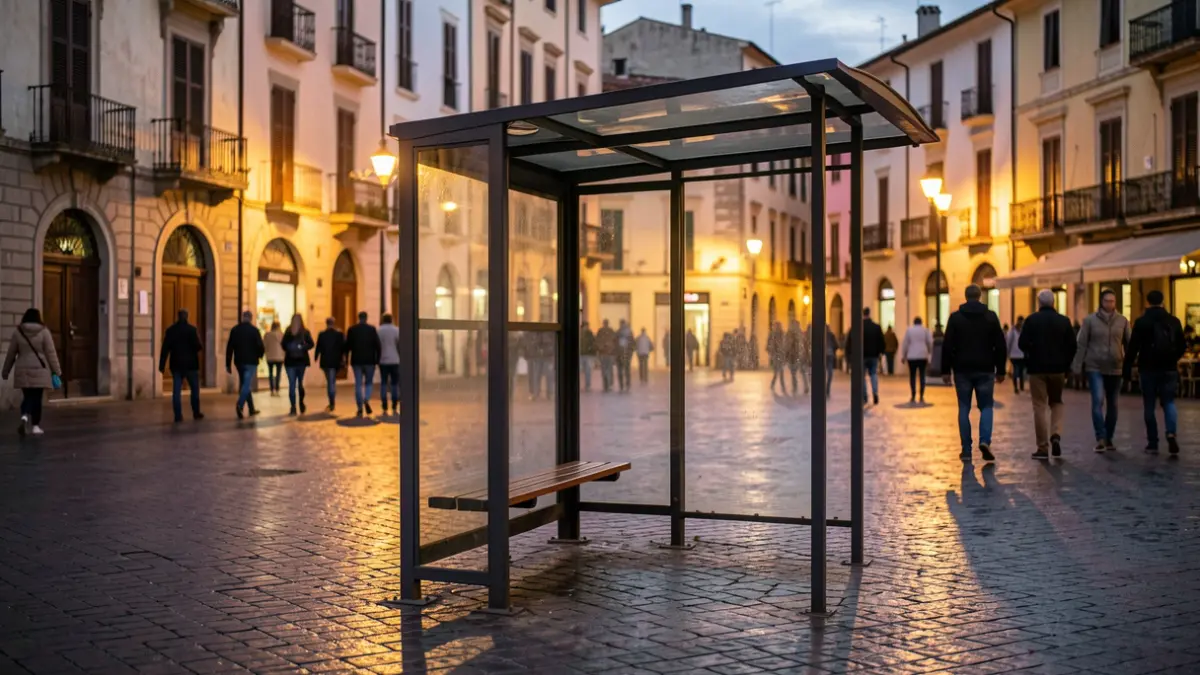 Empty bus stop at dusk in a Mediterranean square.