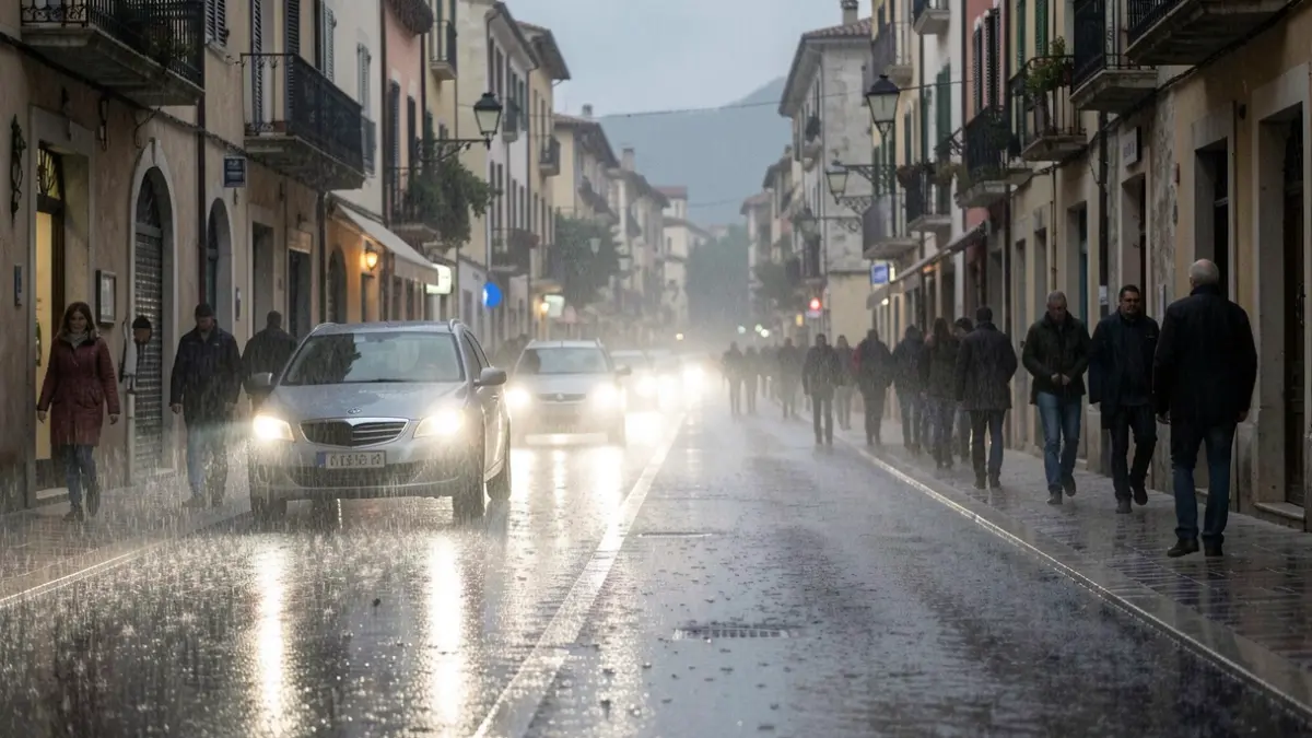 Generic image of heavy rain falling on an urban street with reflections on the wet asphalt.